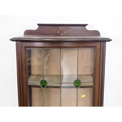 28 - An Edwardian mahogany and inlaid lead glazed bow fronted Display Cabinet fitted single door mounted ... 