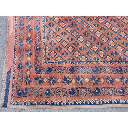 300 - An antique Turkoman Rug with multiple borders with floral designs, and rows of  motifs on a red grou... 