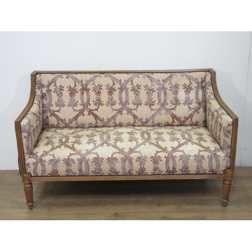 332 - An antique beech framed Settee with trellis floral upholstery on cream ground mounted upon fluted su... 