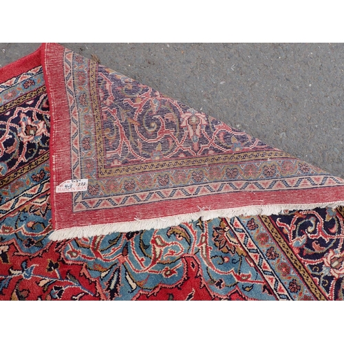 344 - A Persian Carpet of multi-bordered design, with all-over design of flowers and scrolls, on a red gro... 