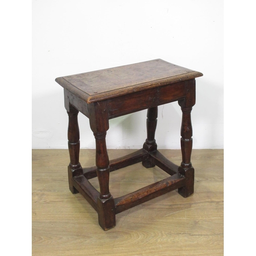 36 - An 18th Century oak Joint Stool with moulded pegged top upon turned supports united by surrounding s... 