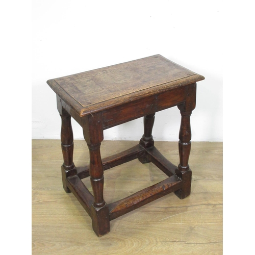 36 - An 18th Century oak Joint Stool with moulded pegged top upon turned supports united by surrounding s... 