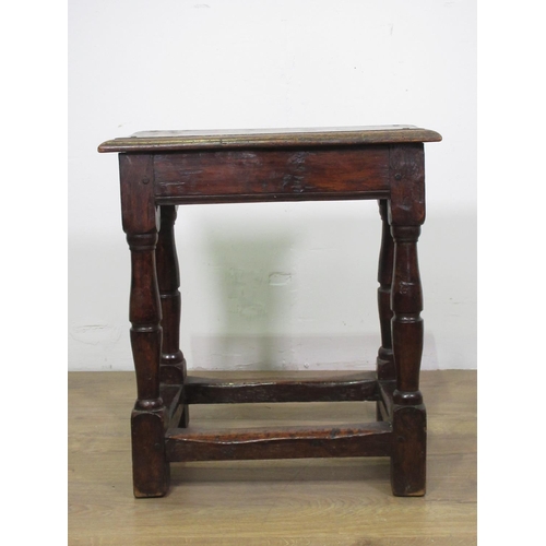 36 - An 18th Century oak Joint Stool with moulded pegged top upon turned supports united by surrounding s... 