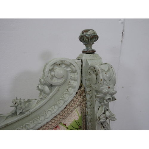 427 - A 19th Century French green painted and floral carved Settee with white trailing geranium decorated ... 