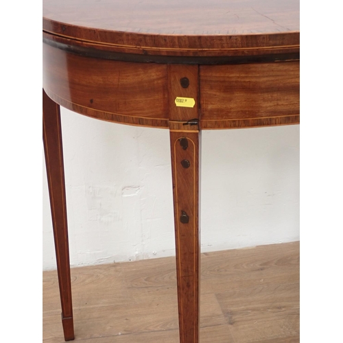 43 - A Georgian mahogany and rosewood crossbanded fold-over Tea Table mounted upon square cut tapering su... 