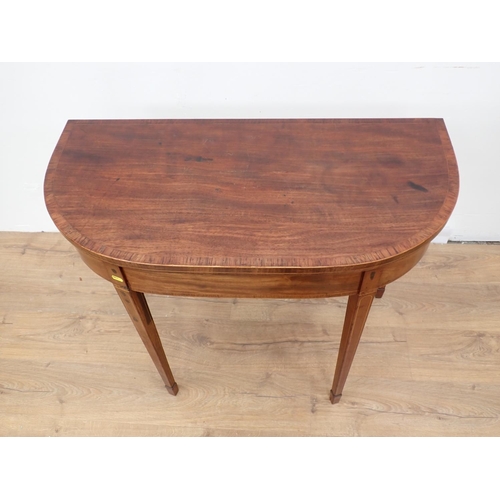 43 - A Georgian mahogany and rosewood crossbanded fold-over Tea Table mounted upon square cut tapering su... 