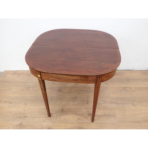 43 - A Georgian mahogany and rosewood crossbanded fold-over Tea Table mounted upon square cut tapering su... 