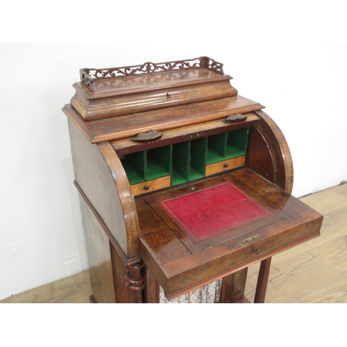 454 - A Victorian walnut veneered Davenport with roll top enclosing fitted interior above glazed cupboard ... 