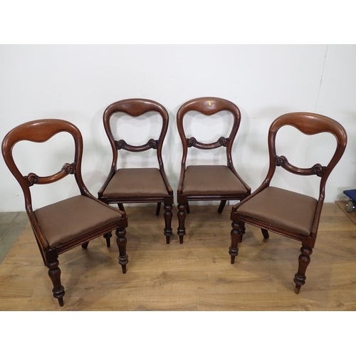 468 - Four Victorian mahogany balloon back Dining Chairs with leather effect drop in seats mounted upon tu... 