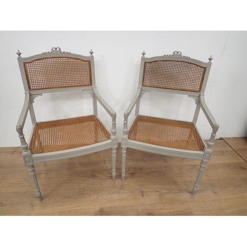 47 - A pair of French green painted cane backed Elbow Chairs 3ft 2in H x 1ft 11in W