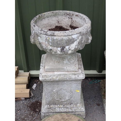 473 - A pair of composite stone Plinths, an Urn, a Pillar Finial, two Mill Stones and a Pedestal