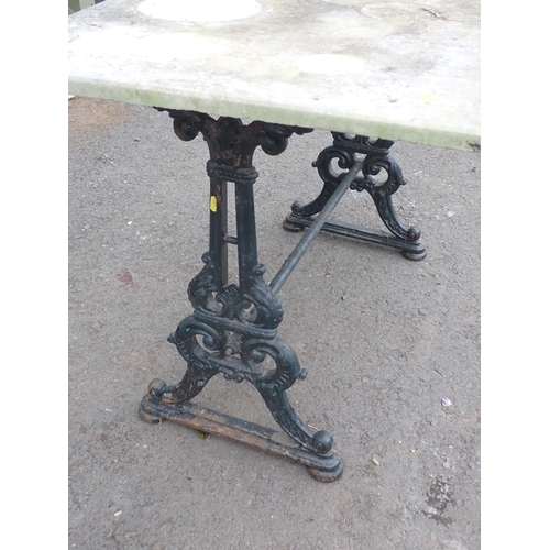 476 - A cast iron Garden Table with stone top 4ft W x 2ft 6in H