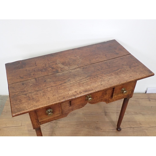 54 - An 18th Century oak Lowboy fitted three drawers above cupid's bow apron mounted upon turned supports... 