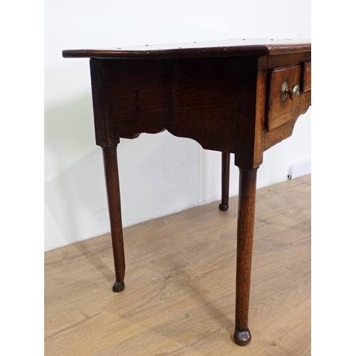 54 - An 18th Century oak Lowboy fitted three drawers above cupid's bow apron mounted upon turned supports... 