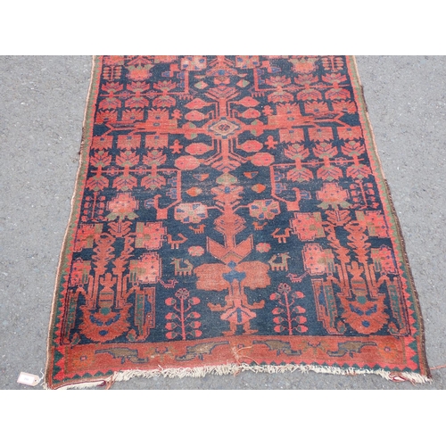 552 - A Persian Runner with red stylised motifs on a blue ground, 17ft x 4ft