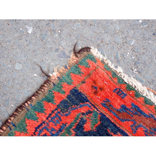 552 - A Persian Runner with red stylised motifs on a blue ground, 17ft x 4ft