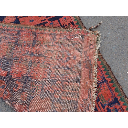 552 - A Persian Runner with red stylised motifs on a blue ground, 17ft x 4ft