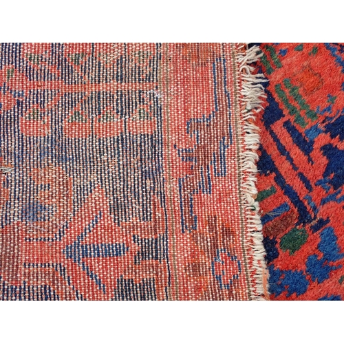 552 - A Persian Runner with red stylised motifs on a blue ground, 17ft x 4ft