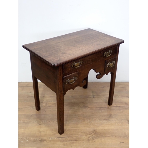 560 - An 18th Century oak Lowboy fitted three drawers above shaped apron mounted upon square cut supports ... 