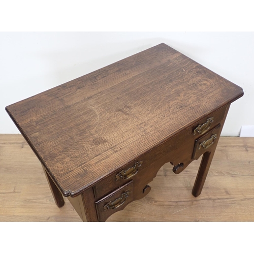 560 - An 18th Century oak Lowboy fitted three drawers above shaped apron mounted upon square cut supports ... 