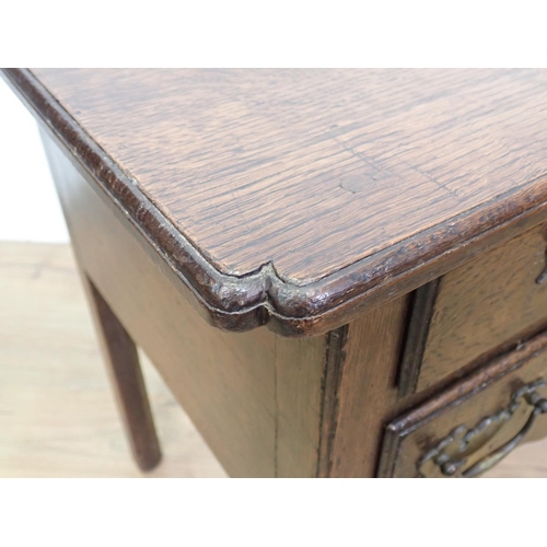 560 - An 18th Century oak Lowboy fitted three drawers above shaped apron mounted upon square cut supports ... 