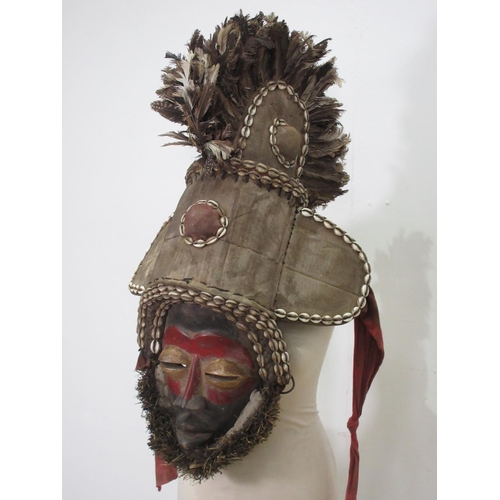 568 - A West African ceremonial Mask with feather head dress