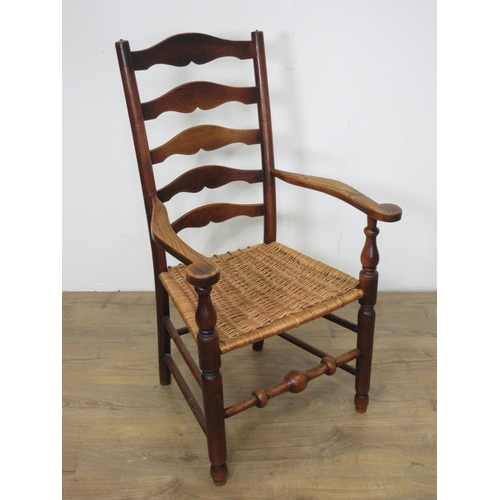 594 - A 19th Century ash ladderback Elbow Chair with wicker seat