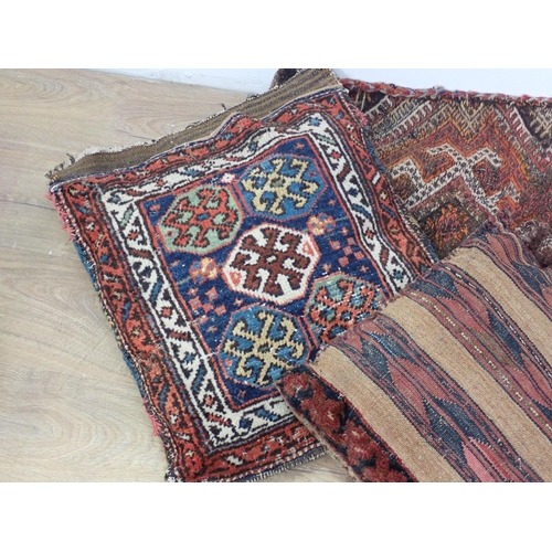 652 - A North African rug Saddle Bag and two Cushions