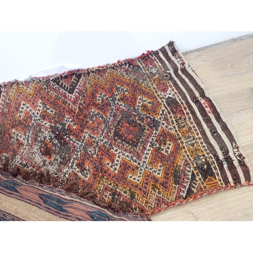 652 - A North African rug Saddle Bag and two Cushions