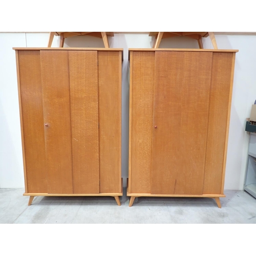 669 - A 20th Century Bedroom Suite comprising two Wardrobes, two Chests of Drawers and a Dressing Chest