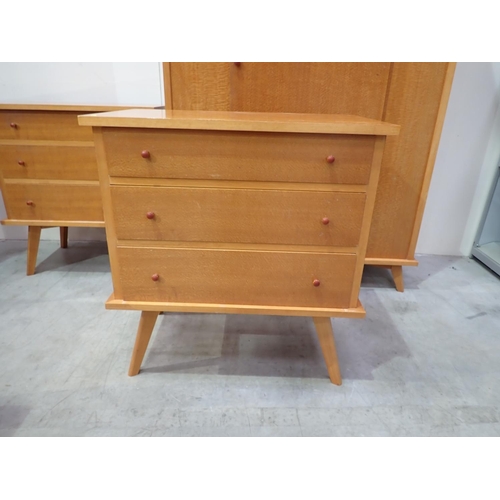 669 - A 20th Century Bedroom Suite comprising two Wardrobes, two Chests of Drawers and a Dressing Chest