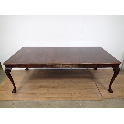 87 - A mahogany extending Dining Table with spare leaf mounted upon carved cabriole supports and claw and... 