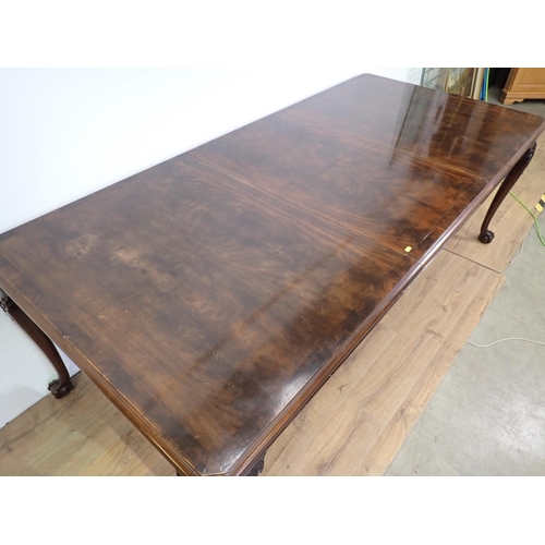 87 - A mahogany extending Dining Table with spare leaf mounted upon carved cabriole supports and claw and... 