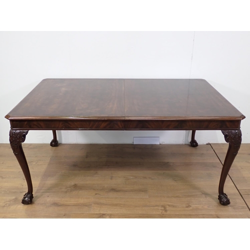 87 - A mahogany extending Dining Table with spare leaf mounted upon carved cabriole supports and claw and... 