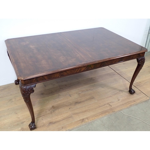 87 - A mahogany extending Dining Table with spare leaf mounted upon carved cabriole supports and claw and... 