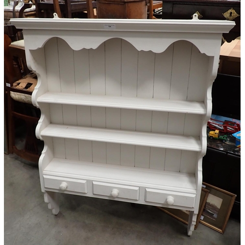 64 - A white painted pine Delft Rack fitted three drawers 3ft 8in H x 2ft 10in W