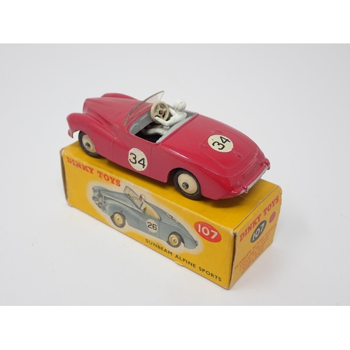 323 - A boxed Dinky Toys No.107 pink Sunbeam Alpine Sports