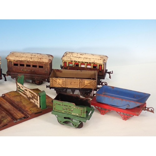 342 - Eight unboxed damaged 0 gauge Wagons and Coaches, an M-series Tender, Level Crossing, Signal and two... 