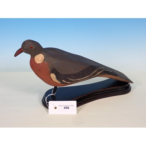 498 - A carved and painted Woodpigeon Decoy with glass eyes on ebonised stand 15in L