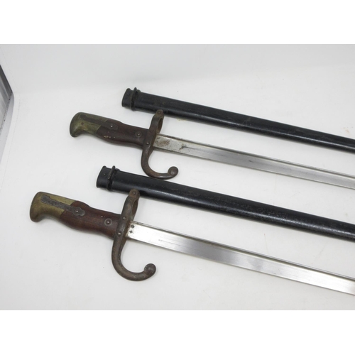 555 - Two 19th Century French Bayonets with metal scabbards engraved and dated to top 1873 and 1876