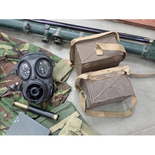 566 - A box containing assorted military items including Camouflage Jacket, Gas Mask, two Shell Cases, Tel... 