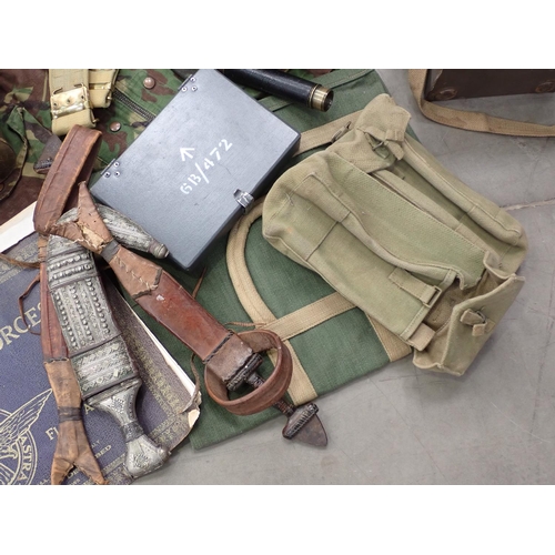 566 - A box containing assorted military items including Camouflage Jacket, Gas Mask, two Shell Cases, Tel... 