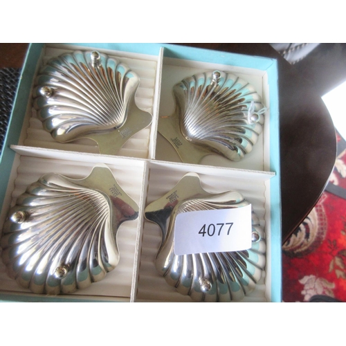 877 - A set of four Tiffany & Co sterling silver shell shaped Nut Dishes, boxed