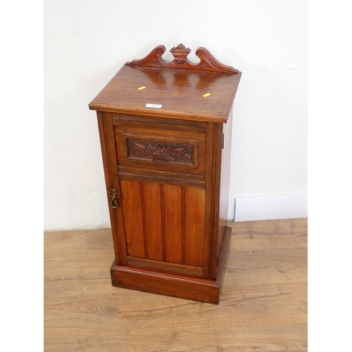 1018 - An Edwardian walnut Bedside Cupboard with carved panelled door