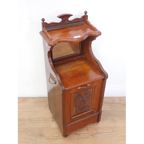 1020 - An Edwardian walnut Coal Purdonium with carved panelled front