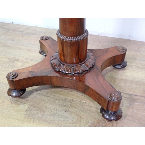 1024 - A William IV rosewood Teapoy of sarcophagus shape on tapering column, carved circular feet and caste... 