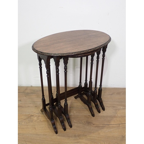 1027 - A Nest of three mahogany oval Tables on turned supports