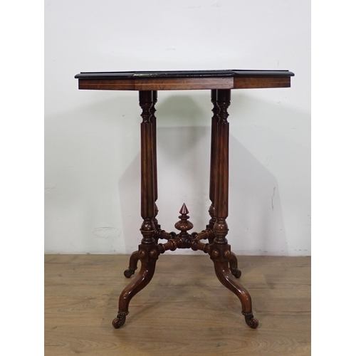 1030 - A Victorian walnut octagonal Table on turned and fluted supports and casters