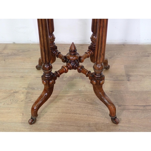 1030 - A Victorian walnut octagonal Table on turned and fluted supports and casters