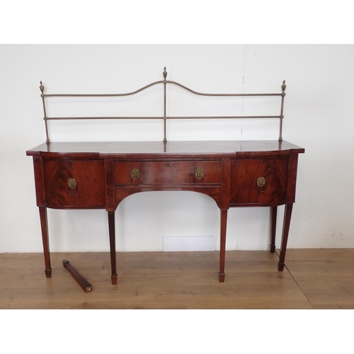 1038 - A Regency mahogany Sideboard with brass rail back, breakfront fitted central drawer flanked by cupbo... 